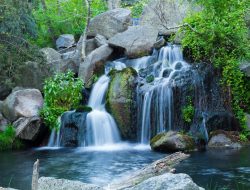 A long exposure shot of waterfall flowing down from rock formations