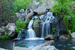 A long exposure shot of waterfall flowing down from rock formations